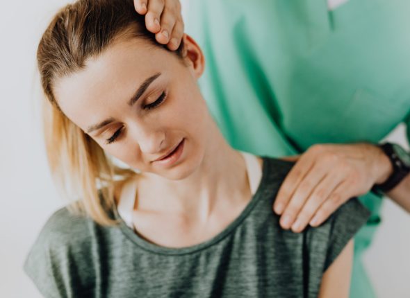 Canva - Crop massage therapist rubbing patients neck